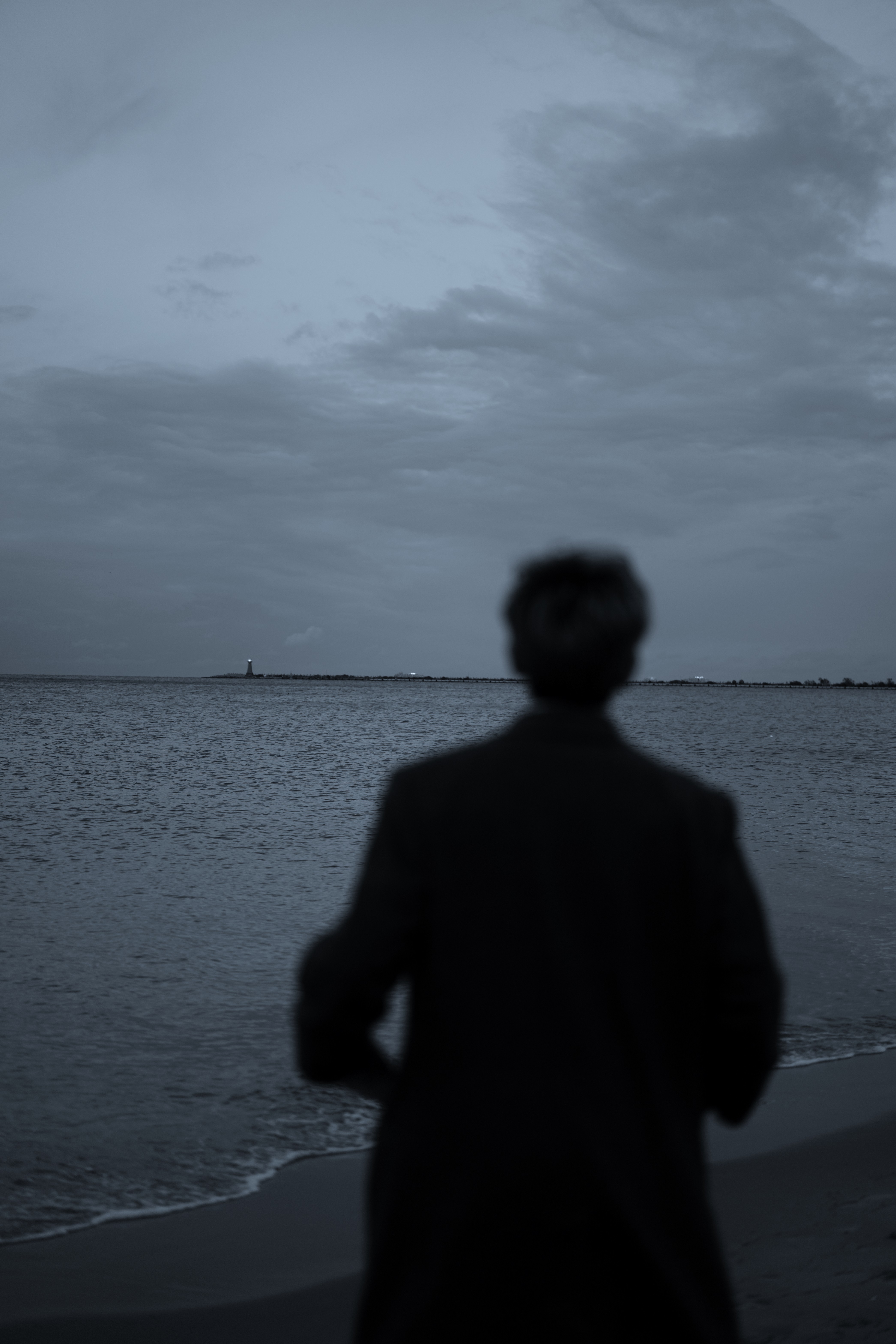 a blurry photo of a person standing in front of a wall